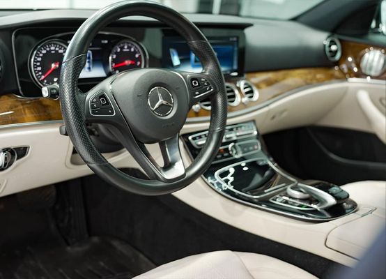 the interior of a mercedes benz car with a steering wheel and dashboard